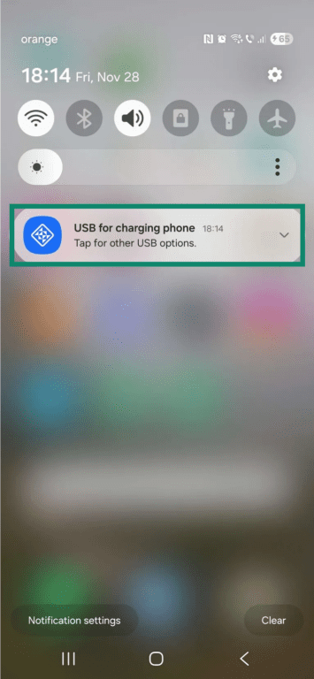 The home screen on an Android phone. The "USB for charging phone" notification is in focus and highlighted.