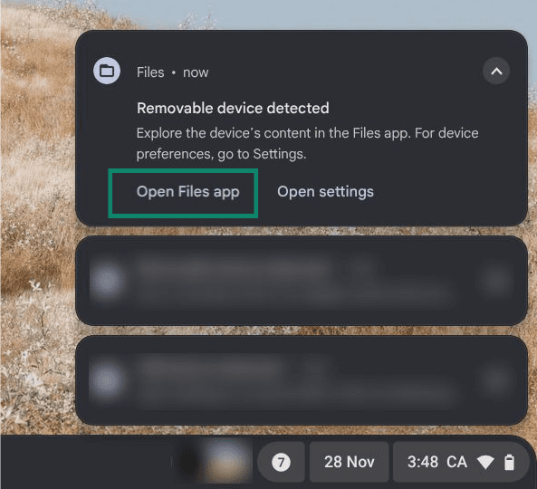 The main screen on a Chromebook, showing a few notification prompts. The "Open Files app" button on one notification is highlighted.